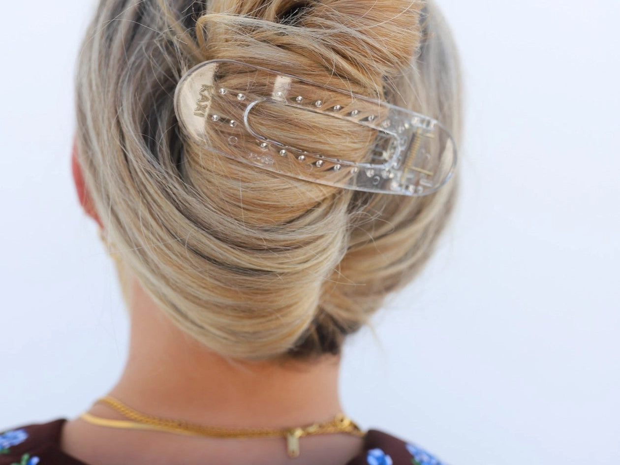 Kaxi Lay Down Claw hair clip in Shiny Clear holding a French twist, back view