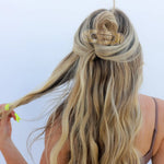Kaxi Lay Down Claw hair clip in taupe holding a half-up style in long blonde hair