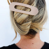 Kaxi Lay Down Claw hair clip in taupe holding a blonde twist, back view