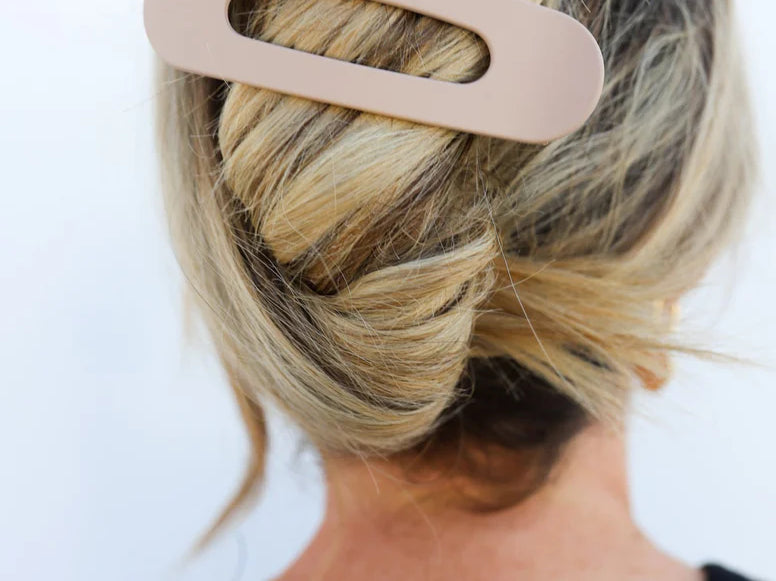 Kaxi Lay Down Claw hair clip in taupe holding a blonde twist, back view