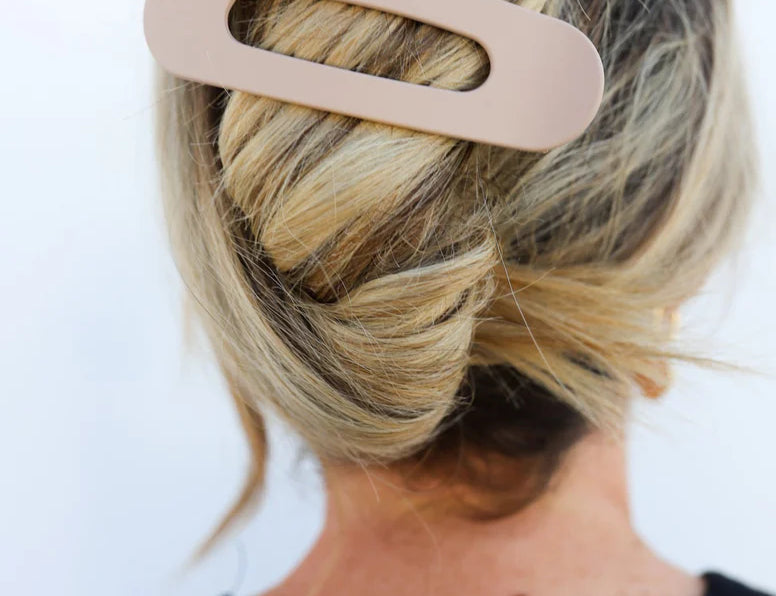 Kaxi Lay Down Claw hair clip in taupe holding a blonde twist, back view