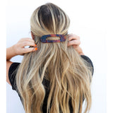 Kaxi Lay Down Claw hair clip in dark tortoise holding a half-up style in long blonde hair