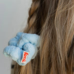 Close-up of the Kaxi Midi Towel Scrunchie in Baby Blue on a braid