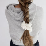 Kaxi Midi Towel Scrunchie in Cream tied at the end of a long braid, back view