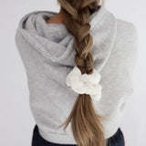 Kaxi Midi Towel Scrunchie in Cream tied at the end of a long braid, back view