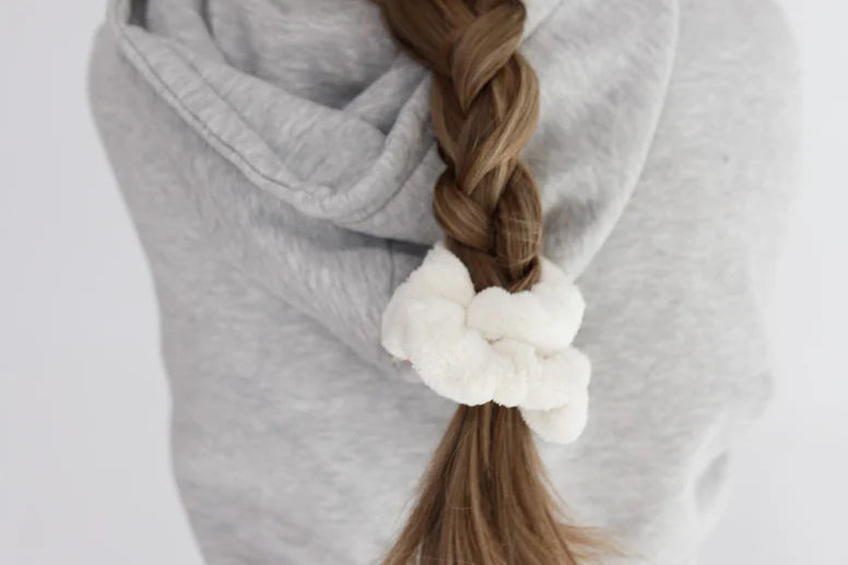 Kaxi Midi Towel Scrunchie in Cream tied at the end of a long braid, back view