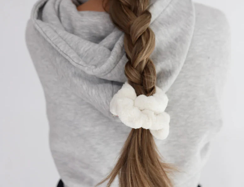 Kaxi Midi Towel Scrunchie in Cream tied at the end of a long braid, back view