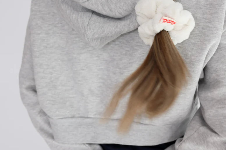 Kaxi Midi Towel Scrunchie in Cream tied in a side ponytail, back view