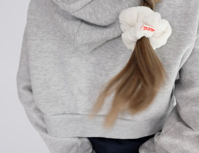 Kaxi Midi Towel Scrunchie in Cream tied in a side ponytail, back view