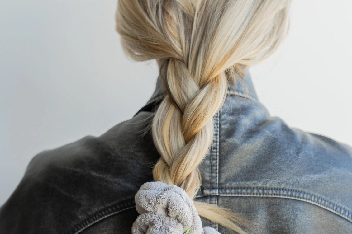 Kaxi Midi Towel Scrunchie in Light Grey tied at the end of a long braid, back view