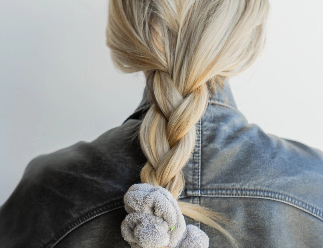 Kaxi Midi Towel Scrunchie in Light Grey tied at the end of a long braid, back view