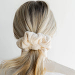 Kaxi Oversized Towel Scrunchie in cream worn in a low bun, back view