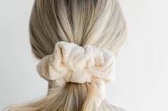 Kaxi Oversized Towel Scrunchie in cream worn in a low bun, back view