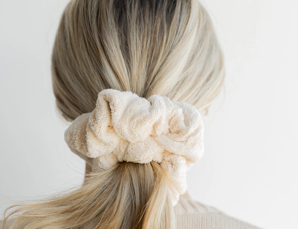 Kaxi Oversized Towel Scrunchie in cream worn in a low bun, back view