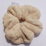 Kaxi Oversized Towel Scrunchie in tan, a plush fluffy scrunchie on white