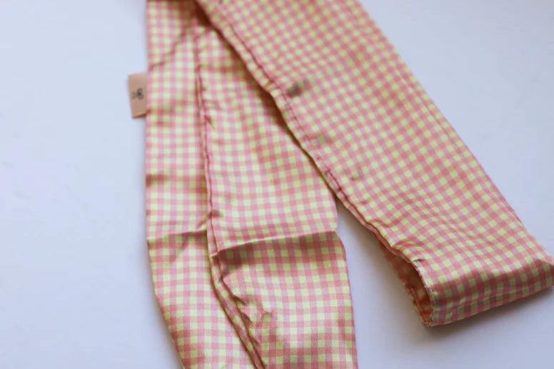 Kaxi Pink Plaid Hair Scarf laid loosely on white showing the gingham print