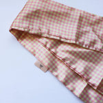 Kaxi Pink Plaid Hair Scarf, a pink and cream gingham satin scarf, folded on white