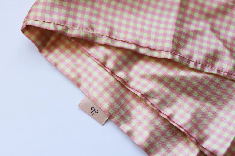 Kaxi Pink Plaid Hair Scarf, a pink and cream gingham satin scarf, folded on white