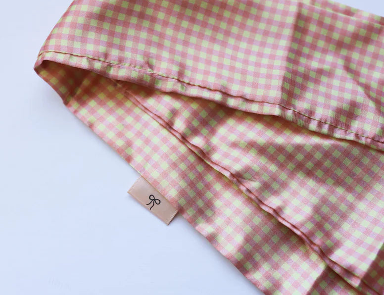 Kaxi Pink Plaid Hair Scarf, a pink and cream gingham satin scarf, folded on white