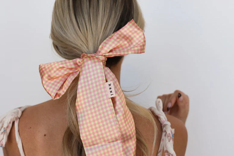 Kaxi Pink Plaid Hair Scarf tied around a low ponytail with long tails, back view