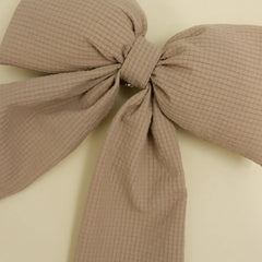 Kaxi Puffy Bow in Bloom, a taupe textured fabric bow, close-up