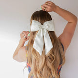 Kaxi Puffy Bow in cream clipped into long blonde hair, back view