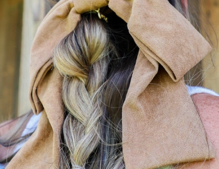Kaxi Suede Slouchy Bow in camel clipped over a braided hairstyle, back view