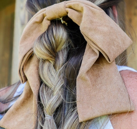 Kaxi Suede Slouchy Bow in camel clipped over a braided hairstyle, back view