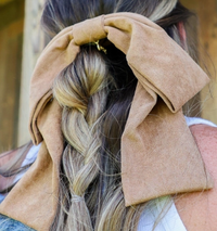 Kaxi Suede Slouchy Bow in camel clipped over a braided hairstyle, back view