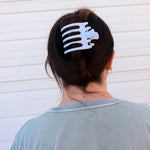 Kaxi Wide Lay Down Claw in Baby Blue holding a dark hair updo, back view