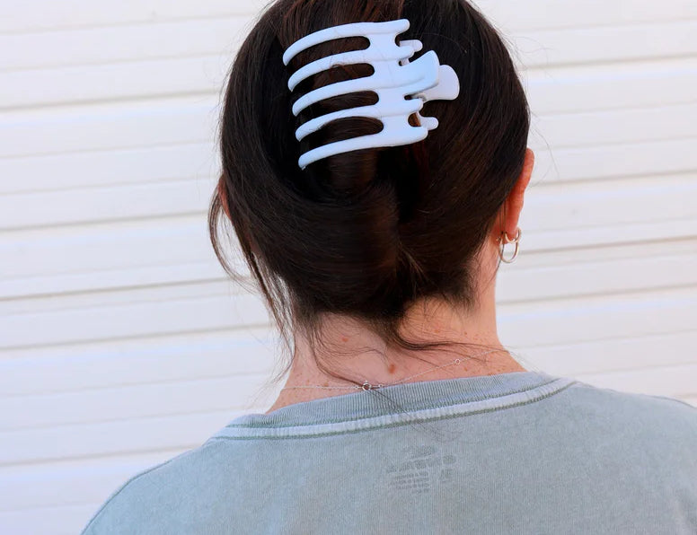 Kaxi Wide Lay Down Claw in Baby Blue holding a dark hair updo, back view