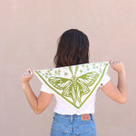 Woman holding the Kei & Molly Cotton Bandana in Moth green print open behind her back