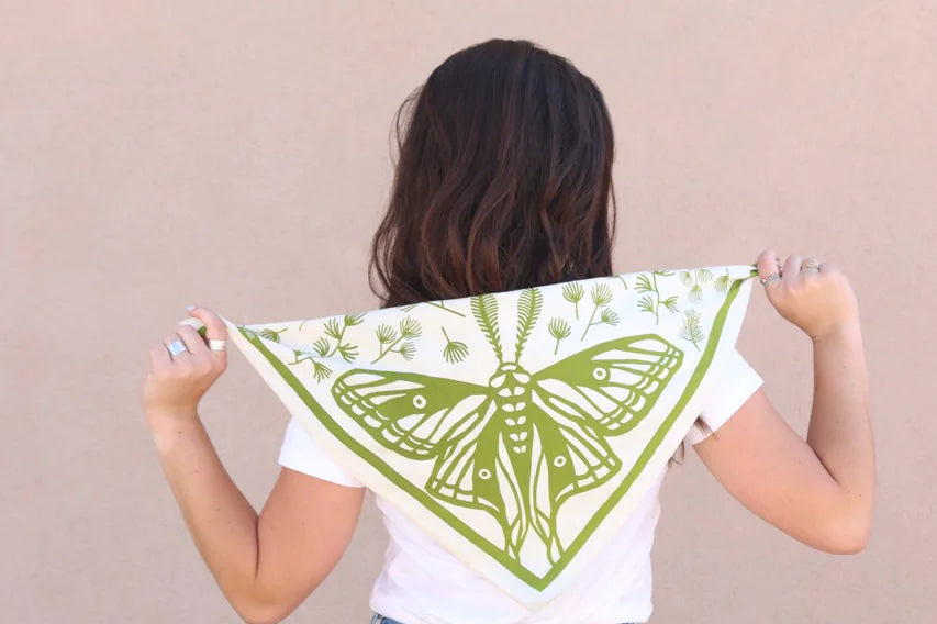 Woman holding the Kei & Molly Cotton Bandana in Moth green print open behind her back