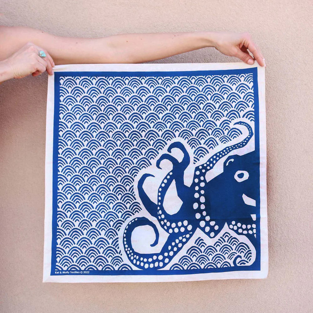Kei & Molly Cotton Bandana in Octopus, a navy blue bandana with a white octopus and wave print, held flat