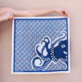 Kei & Molly Cotton Bandana in Octopus, a navy blue bandana with a white octopus and wave print, held flat