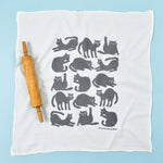Kei & Molly Flour Sack Dish Towel in Grey Cats, a white towel with a grid of gray cat silhouettes