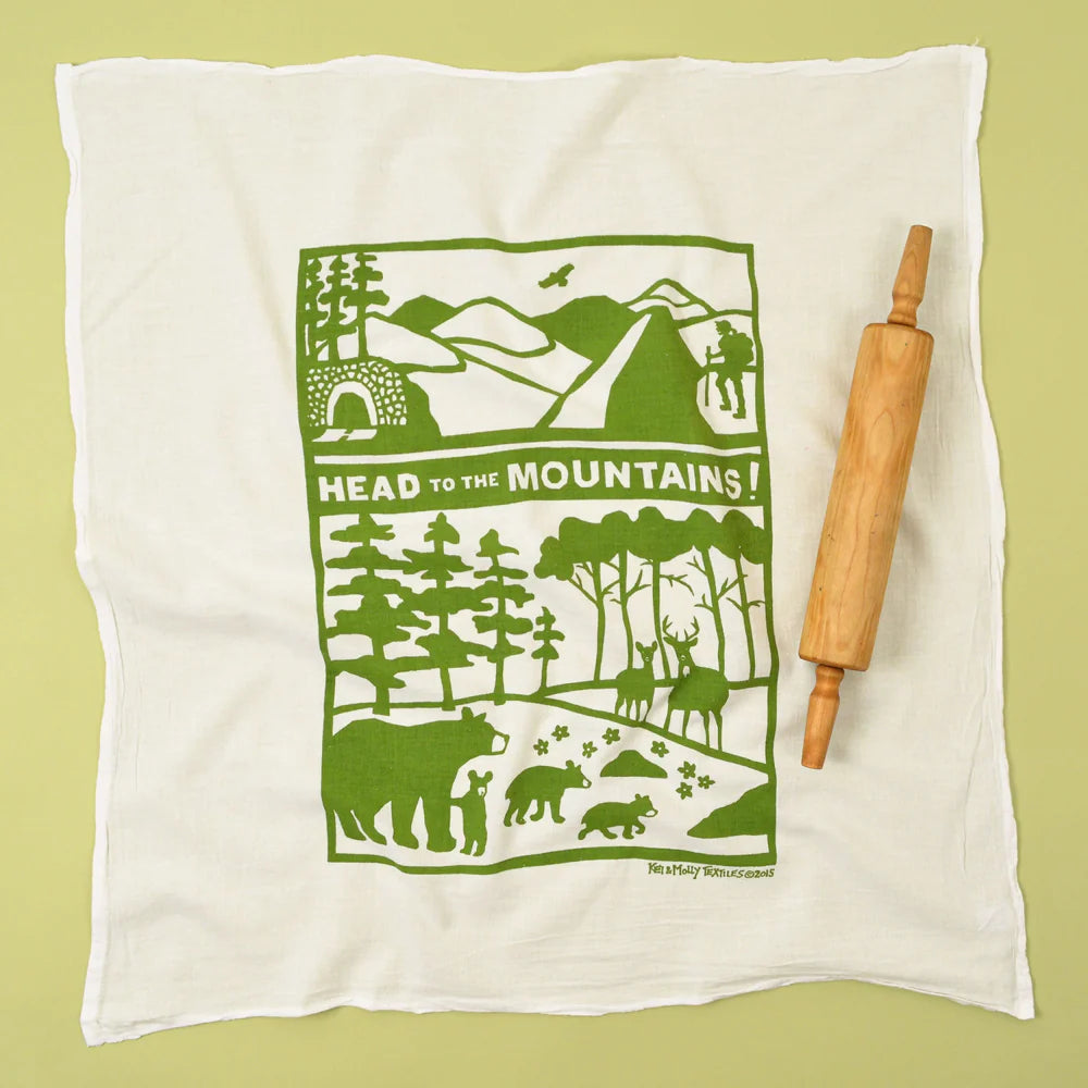 Kei & Molly Flour Sack Dish Towel in Head to the Mountains, a white towel with a green mountain and bear print