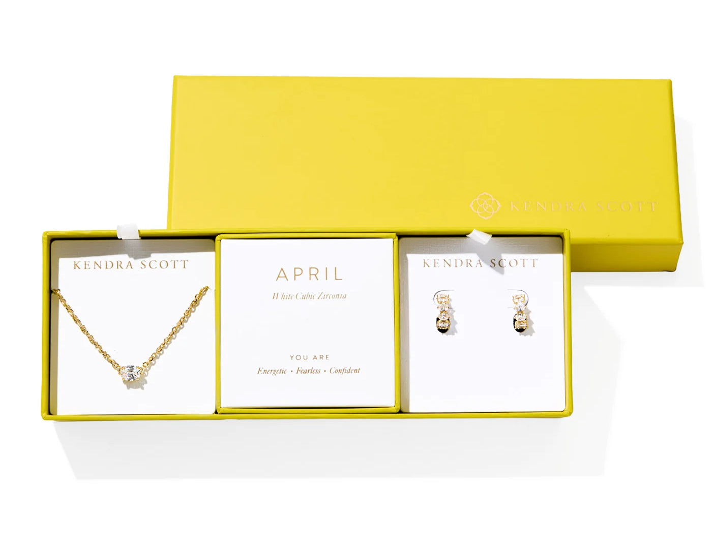Kendra Scott Cailin Birthstone Gift Set for April in gold with White CZ, a pendant necklace and huggie earrings in a yellow gift box