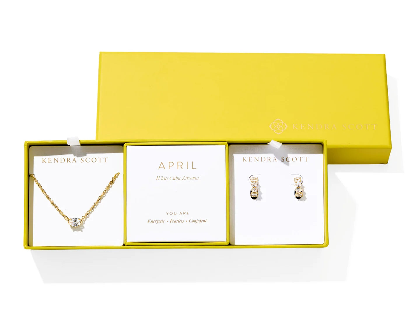 Kendra Scott Cailin Birthstone Gift Set for April in gold with White CZ, a pendant necklace and huggie earrings in a yellow gift box