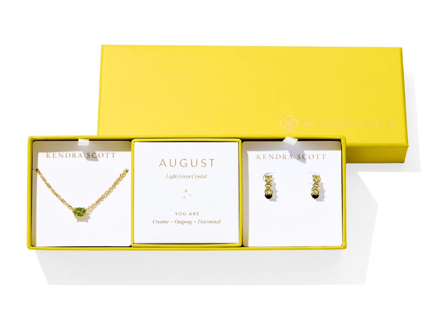 Kendra Scott Cailin Birthstone Gift Set for August in gold with Light Green Crystal, a pendant necklace and huggie earrings in a yellow gift box