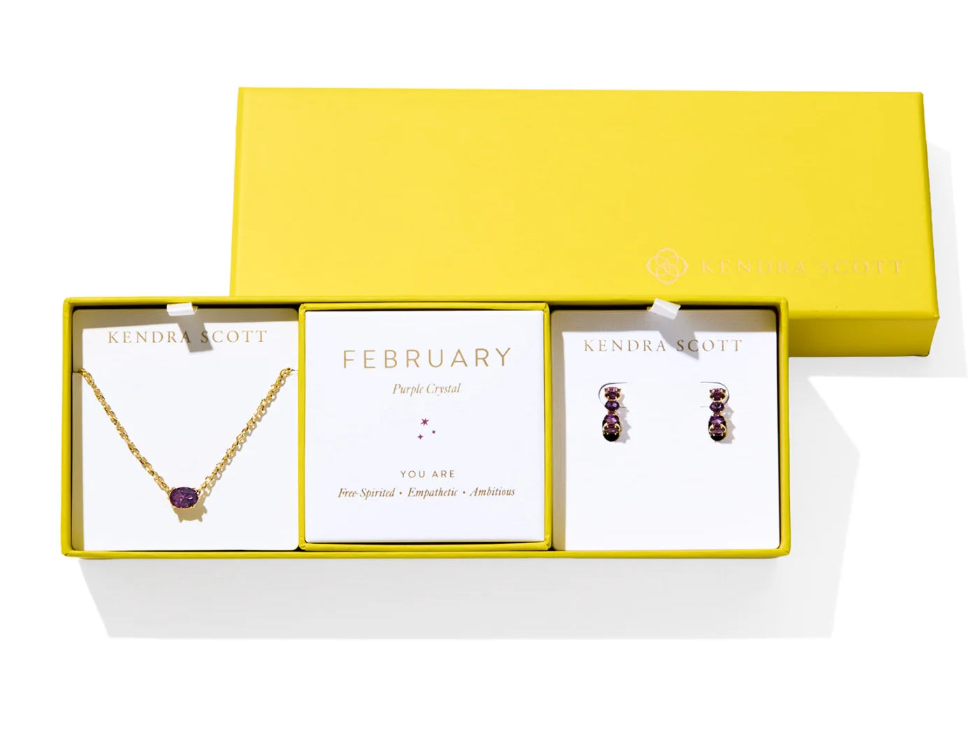 Kendra Scott Cailin Birthstone Gift Set for February in gold with Purple Crystal, a pendant necklace and huggie earrings in a yellow gift box