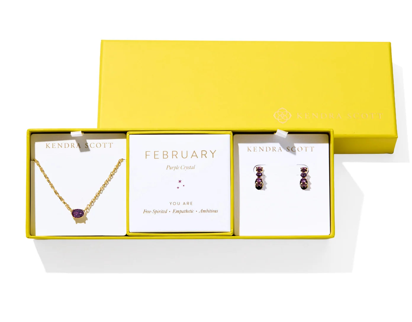 Kendra Scott Cailin Birthstone Gift Set for February in gold with Purple Crystal, a pendant necklace and huggie earrings in a yellow gift box