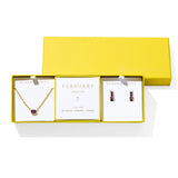 Kendra Scott Cailin Birthstone Gift Set for February in gold with Purple Crystal, a pendant necklace and huggie earrings in a yellow gift box
