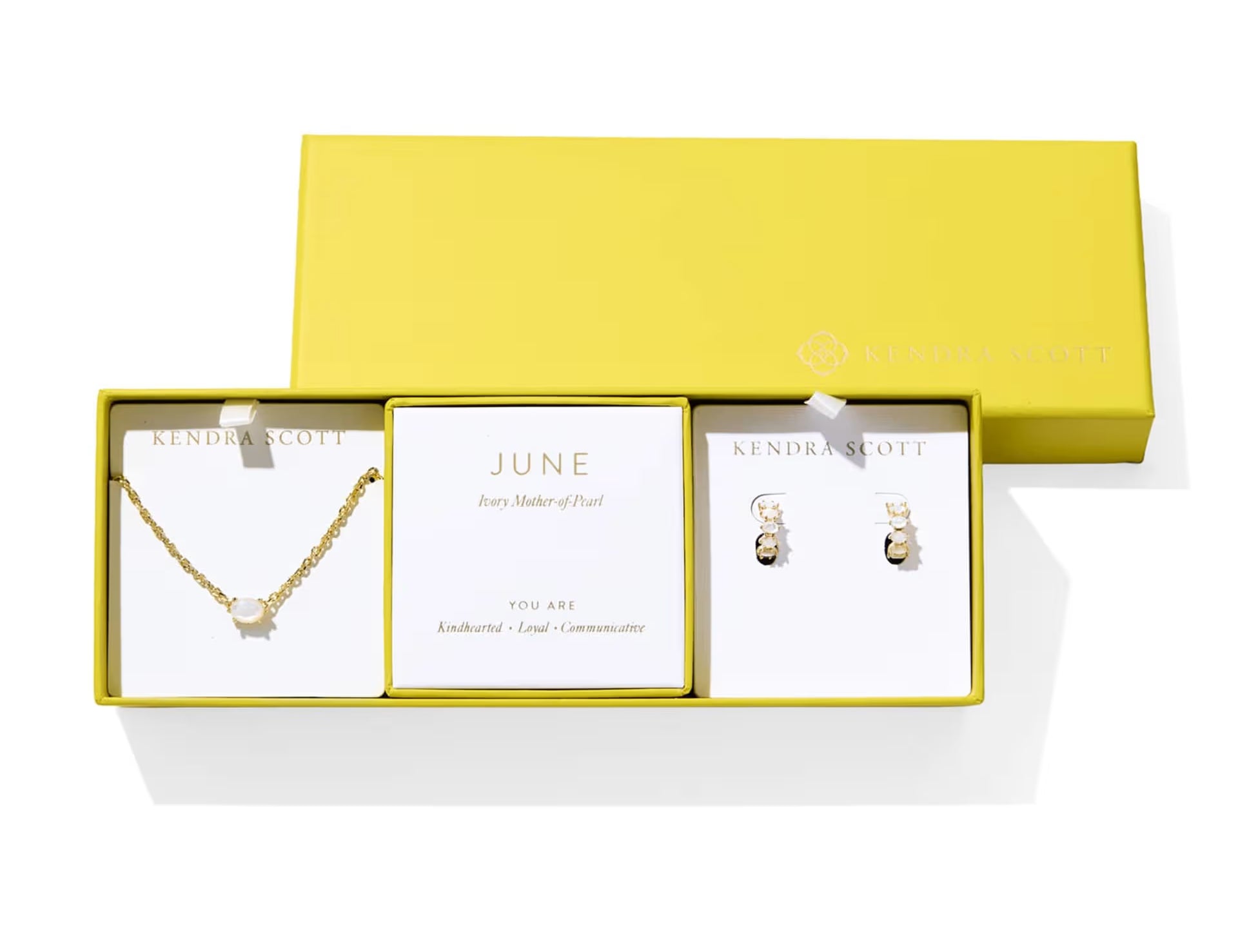 Kendra Scott Cailin Birthstone Gift Set for June in gold with Ivory Mother of Pearl, a pendant necklace and huggie earrings in a yellow gift box