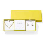 Kendra Scott Cailin Birthstone Gift Set for June in gold with Ivory Mother of Pearl, a pendant necklace and huggie earrings in a yellow gift box