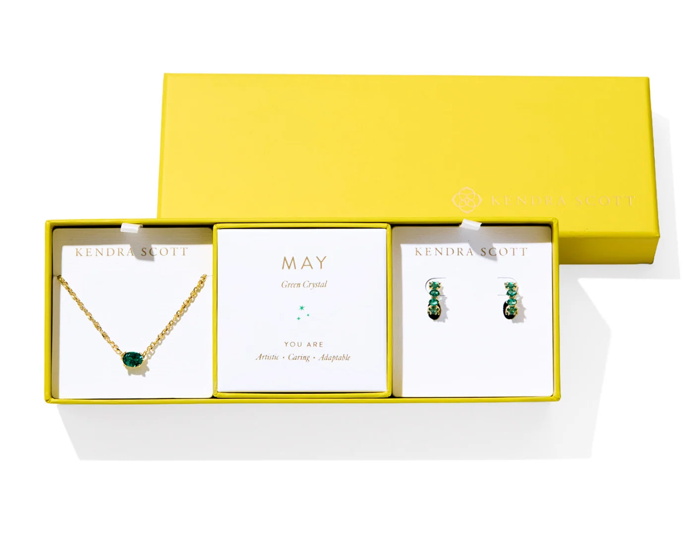 Kendra Scott Cailin Birthstone Gift Set for May in gold with Green Crystal, a pendant necklace and huggie earrings in a yellow gift box