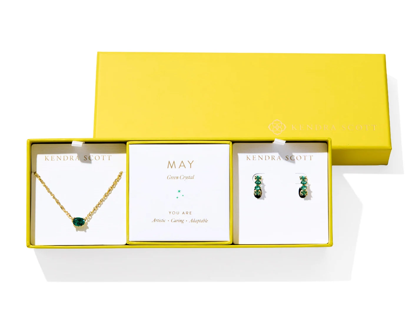 Kendra Scott Cailin Birthstone Gift Set for May in gold with Green Crystal, a pendant necklace and huggie earrings in a yellow gift box
