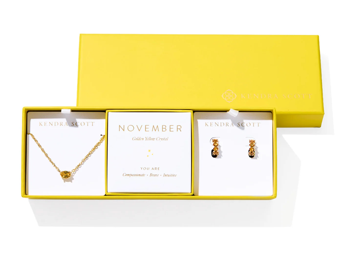 Kendra Scott Cailin Birthstone Gift Set for November in gold with Golden Yellow Crystal, a pendant necklace and huggie earrings in a yellow gift box