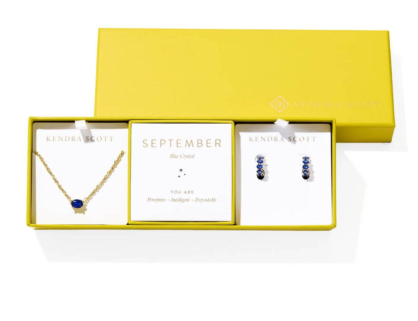 Kendra Scott Cailin Birthstone Gift Set for September in gold with Blue Crystal, a pendant necklace and huggie earrings in a yellow gift box