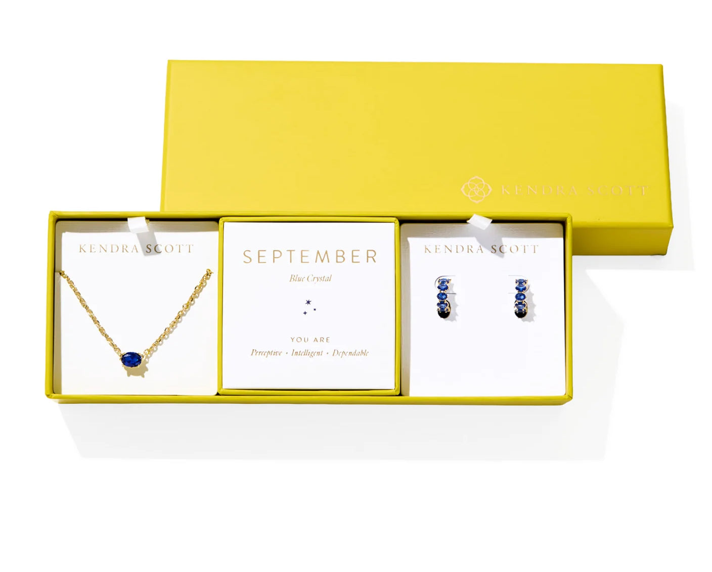 Kendra Scott Cailin Birthstone Gift Set for September in gold with Blue Crystal, a pendant necklace and huggie earrings in a yellow gift box
